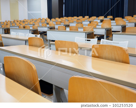 Desks and chairs inside a bright classroom at school 101253520
