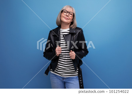 successful healthy gray-haired woman 50s grandmother businesswoman in a rocker jacket on a bright 101254022