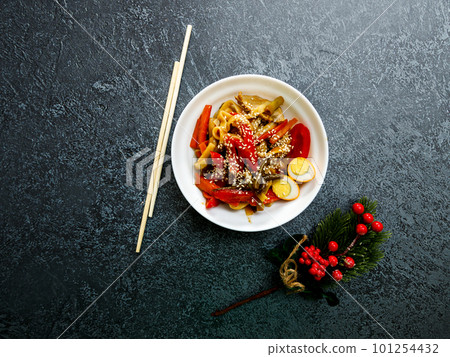 A bowl of soba noodles with mushrooms, onions and 101254432