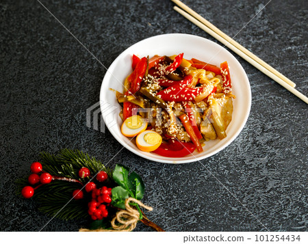 A bowl of soba noodles with mushrooms, onions and 101254434