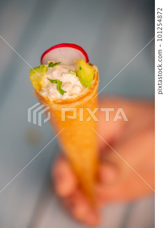 Brick cone with tuna sauce, mayonnaise, avocado and radish slice 101254872