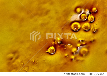 Image texture of a dull caramel (amber) viscous bubbly liquid 101255364
