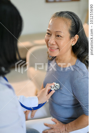 Happy senior Asian woman is having her heart and lungs checked by a doctor at the hospital 101255690