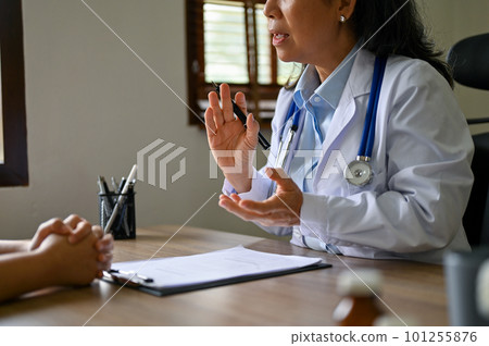 A senior Asian female doctor having a medical meeting with her patient 101255876