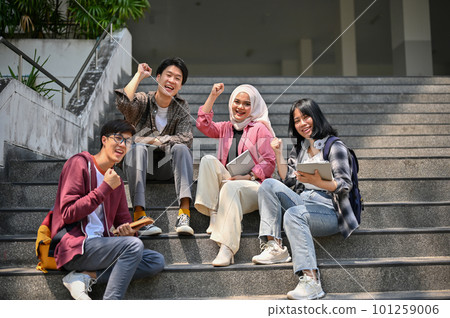 A group of Asian-diverse college students rejoicing and celebrating their school success A group of Asian-diverse college students rejoicing and celebrating their school success 101259006