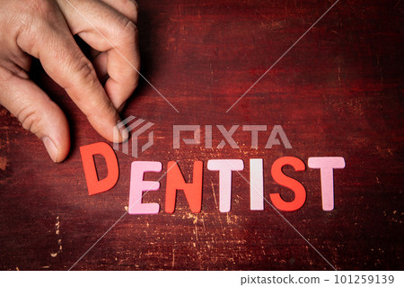 DENTIST Concept. text from colorful alphabet letters on a painted wooden background 101259139