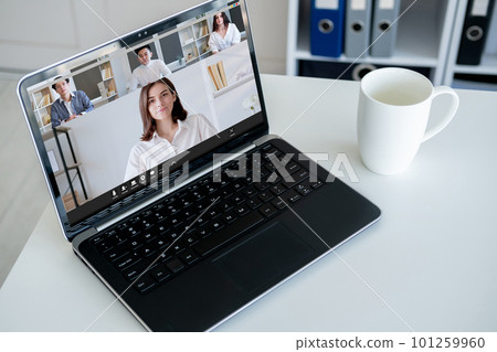 Online meeting. Web chat. Distant briefing. Diverse professional business team discussing work on laptop screen at office workplace. Online meeting. Web chat. Distant briefing. Diverse professional business team discussing work on laptop screen at office workplace. 101259960