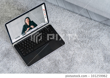 Video interview. Web chat. Online communication. Cheerful business woman on laptop screen at digital office on floor with free space. Video interview. Web chat. Online communication. Cheerful business woman on laptop screen at digital office on floor with free space. 101259962