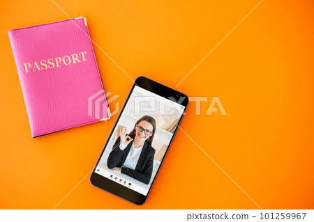 Passport service. Online expert. Digital immigration center. Satisfied business woman approving visa with okay gesture on phone screen on orange copy space background. 101259967