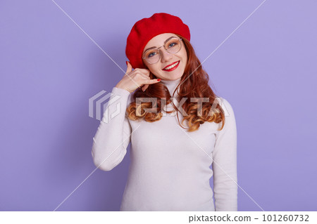 Woman in glasses doing phone gesture like says 101260732