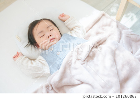 A baby sleeping in a room with sunshine filtering through trees Nap A baby sleeping in a room with sunshine filtering through trees Nap 101260862