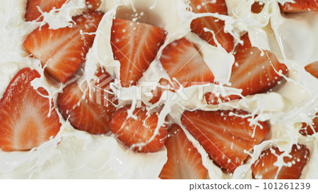 Freeze motion of whirling milk cream with strawberries, close-up 101261239