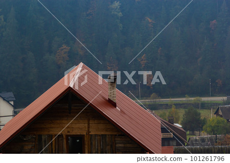 House with new brown metal tile roof and rain gutter. Metallic Guttering System, Guttering and Drainage Pipe Exterior House with new brown metal tile roof and rain gutter. Metallic Guttering System, Guttering and Drainage Pipe Exterior 101261796