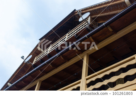 House with new brown metal tile roof and rain gutter. Metallic Guttering System, Guttering and Drainage Pipe Exterior House with new brown metal tile roof and rain gutter. Metallic Guttering System, Guttering and Drainage Pipe Exterior 101261803