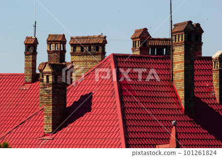Roof of a new home. Ceramic chimney, metal roof tiles, gutters, roof window. Single family house Roof of a new home. Ceramic chimney, metal roof tiles, gutters, roof window. Single family house 101261824
