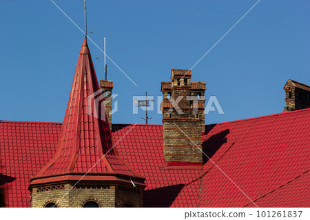Red house roof with red brick chimney. Ceramic chimney, metal roof tiles, gutters 101261837