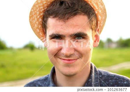 Portrait young man on nature summer background. Smiling young man. 20s years. Handsome man outdoors portrait. Lifestyle. Farmer. Out of focus Portrait young man on nature summer background. Smiling young man. 20s years. Handsome man outdoors portrait. Lifestyle. Farmer. Out of focus 101263677