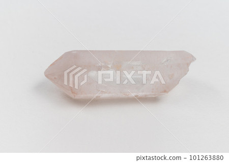 Natural mineral from geological collection raw clear quartz rock crystal stone, white background, close up macro 101263880
