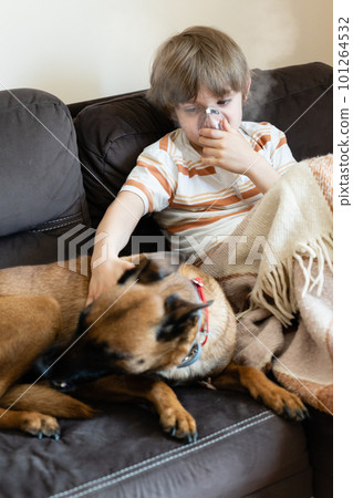 Sick child on the sofa at home with pet Sick child on the sofa at home with pet 101264532