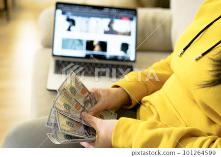 Successful online business concept hands counting dollar bills background of open laptop. It conveys idea of financial success, wealth management, and profitability, providing inspiring image for Successful online business concept hands counting dollar bills background of open laptop. It conveys idea of financial success, wealth management, and profitability, providing inspiring image for 101264599