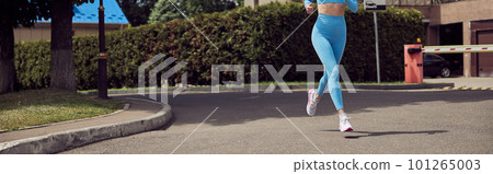 Beautiful fit young woman jogger is running outdoors 101265003