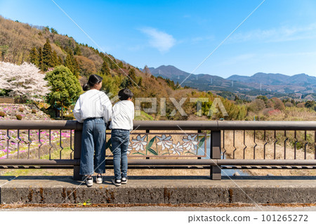 A child looking at the scenery of the countryside against the blue sky 101265272
