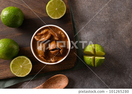 Home made Sri Lankan Lime Pickle of lime, salt, chilli, pepper. 101265280