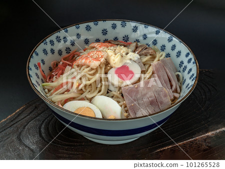 Cold noodles (Ramen) with roast pork sliced, shrimp, ham, boiled egg and lemon sauce in blue bowl. Cold noodles (Ramen) with roast pork sliced, shrimp, ham, boiled egg and lemon sauce in blue bowl. 101265528