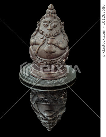 Figurine of Phali, (The Unbeatable Money King) Sculpture Statue with The Reflection Shadow on Black Background. Figurine of Phali, (The Unbeatable Money King) Sculpture Statue with The Reflection Shadow on Black Background. 101265586