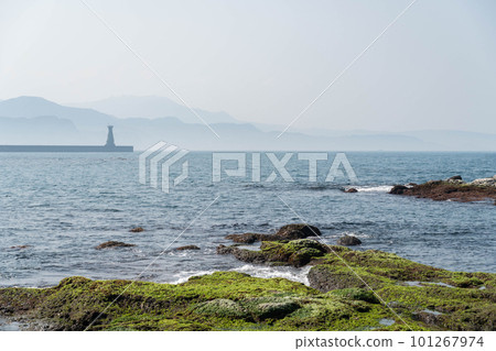 Beautiful ocean view with lighthouse and green moss covered rocks at Heping Island Park, Keelung, Taiwan. 101267974