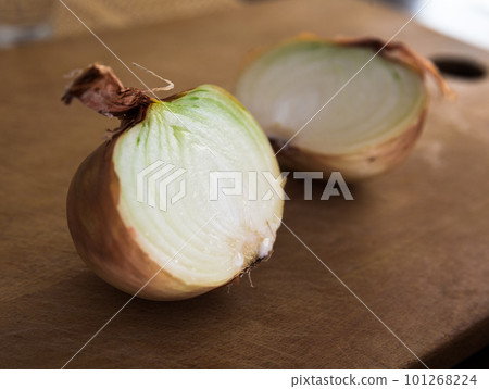 halves of ripe onions on wooden board halves of ripe onions on wooden board 101268224