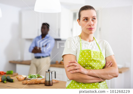 Young woman offended after quarrel with husband in home kitchen 101268229