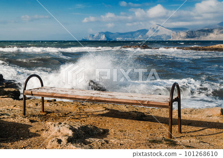 Bench on the background of the sea in a storm 101268610