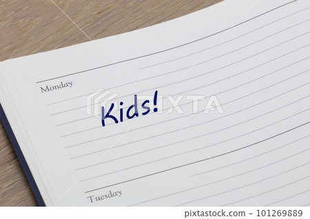 Kids reminder note in blue ink in a diary page 101269889