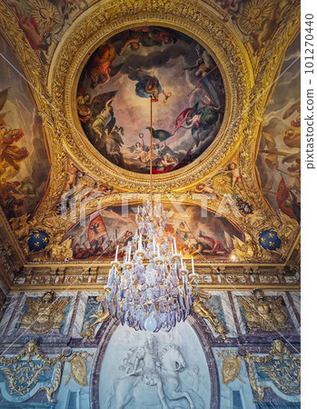 The War Room, Palace of Versailles, France. Chandelier hangs out of the golden painted ceiling above the stucco medallion of Louis XIV on horseback The War Room, Palace of Versailles, France. Chandelier hangs out of the golden painted ceiling above the stucco medallion of Louis XIV on horseback 101270440