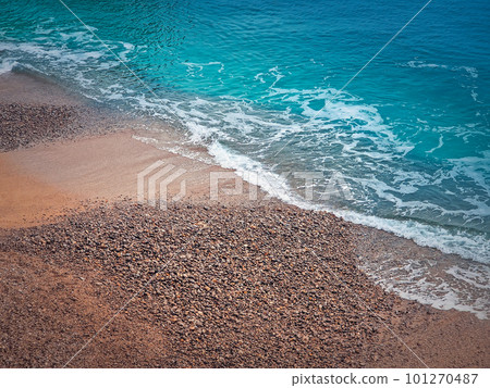 Blue ocean waves hits the shoreline. Beautiful texture of sea water and sandy beach 101270487