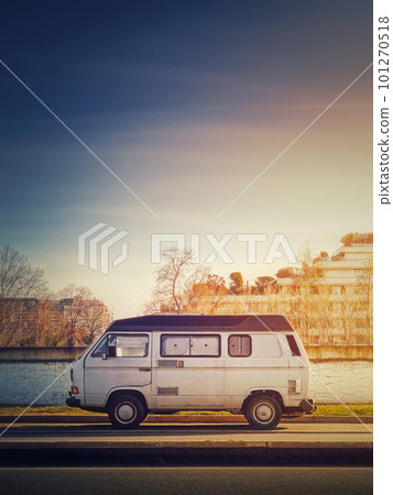 Old van parked on the edge of the street in the sunset sky background, Asnieres sur Seine, Paris suburb, France 101270518