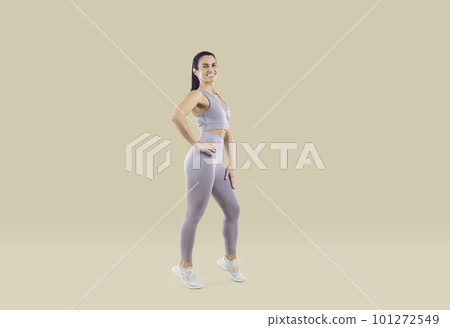 Smiling fit woman in sportswear posing in studio Smiling fit woman in sportswear posing in studio 101272549