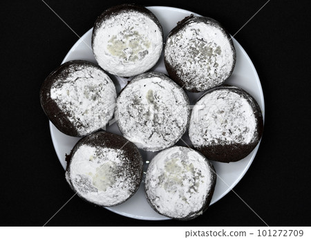 Soft chocolate round cookies on a plate. Delicious cake with filling. Soft chocolate round cookies on a plate. Delicious cake with filling. 101272709
