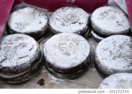 Soft chocolate round cookies in a cardboard box. Delicious cake with filling. Soft chocolate round cookies in a cardboard box. Delicious cake with filling. 101272714