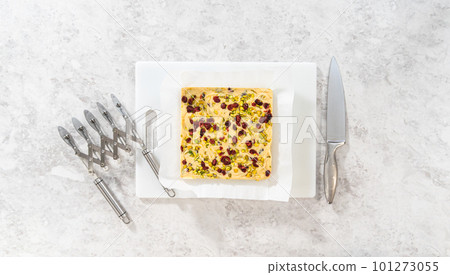 Flat lay. Storing cranberry pistachio fudge into the reusable plastic bag. Flat lay. Storing cranberry pistachio fudge into the reusable plastic bag. 101273055