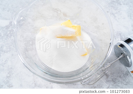 Close up view. Mixing ingredients in a glass mixing bowl to bake funfettti bundt cake. 101273083