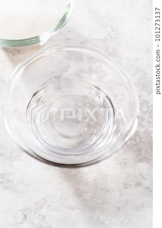 Measured ingredients in glass mixing bowls to prepare simple syrup. Measured ingredients in glass mixing bowls to prepare simple syrup. 101273137