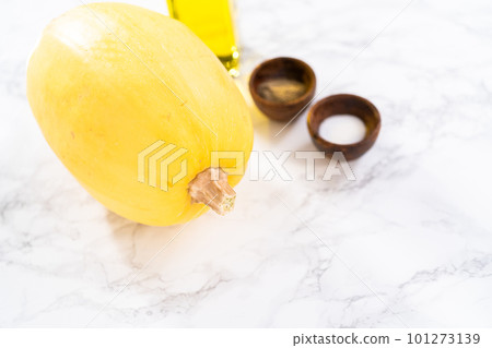Preparing organic spaghetti squash with olive oil, salt, and pepper. 101273139