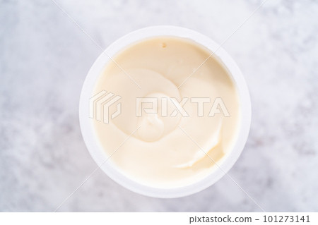 Preparing store-bought buttercream frosting to make unicorn rainbow chocolate cupcakes. Preparing store-bought buttercream frosting to make unicorn rainbow chocolate cupcakes. 101273141