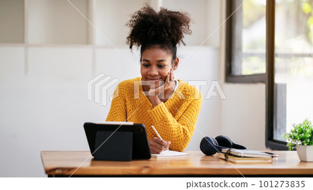 African american student woman in sweater watching e-learning to African american student woman in sweater watching e-learning to 101273835