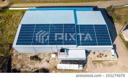Multiple solar panels on the roof of a manufacturing building 101274070