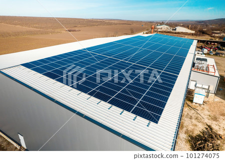 Multiple solar panels on the roof of a manufacturing building 101274075