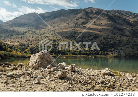 Kournas Mountain Lake in Greece. Cozy summer day and calm water in the lake Kournas Mountain Lake in Greece. Cozy summer day and calm water in the lake 101274238
