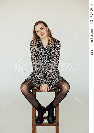 Vertical portrait of a pretty young woman in a black dress with long hair. 101274269